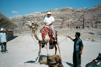 Robert W. Holloway riding a camel at Petra, Jordan.