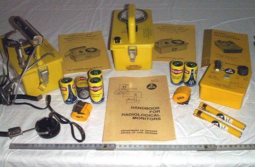 Victoreen Civil Defence V-777-1 shelter radiation detection kit overview. It includes, from left to right: V-700, a true Geiger-Mueller counter, with its headphone and detachable tube; V-715, a ionization chamber; two V-742 stylo-dosimeter (portable dosimeter); V-705, a dosimeter reader; operation manual for every component; two adustable straps for V-700 & V-715; several D-cells to power everything (two D-cell for each - V-742 dosimeter do not require battery).